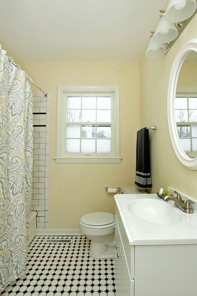 Inspiration for a small contemporary master bathroom in Other with an integrated sink, flat-panel cabinets, white cabinets, solid surface benchtops, a drop-in tub, a shower/bathtub combo, a two-piece toilet, white tile, subway tile, yellow walls and mosaic tile floors.