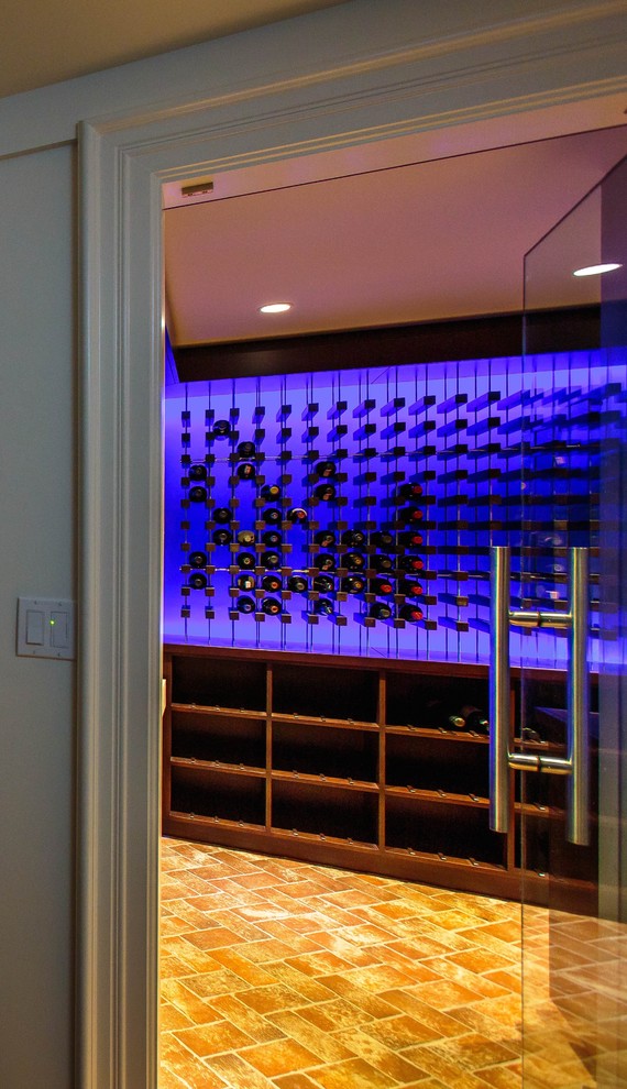 Photo of a contemporary wine cellar in Boston with ceramic floors and display racks.