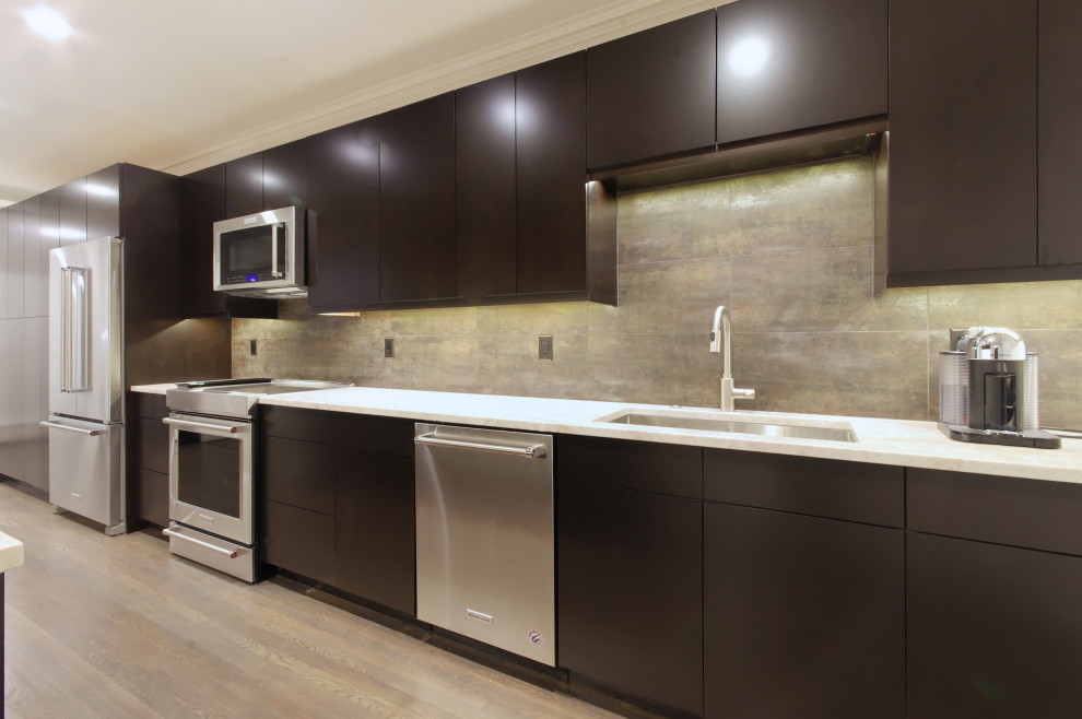 Example of a mid-sized trendy galley medium tone wood floor and brown floor kitchen design in Baltimore with an undermount sink, flat-panel cabinets, dark wood cabinets, quartzite countertops, multicolored backsplash, ceramic backsplash, stainless steel appliances, a peninsula and beige countertops