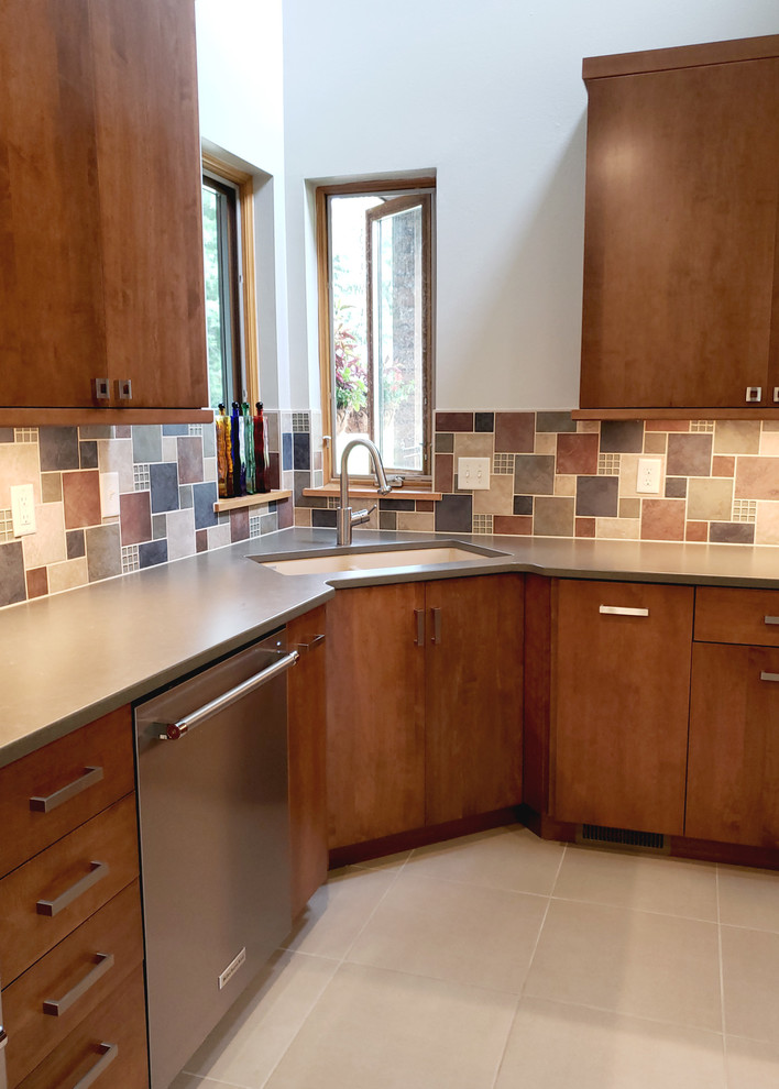 This is an example of a mid-sized modern u-shaped eat-in kitchen in Other with an undermount sink, flat-panel cabinets, medium wood cabinets, quartz benchtops, multi-coloured splashback, slate splashback, stainless steel appliances, concrete floors, with island, grey floor and grey benchtop.