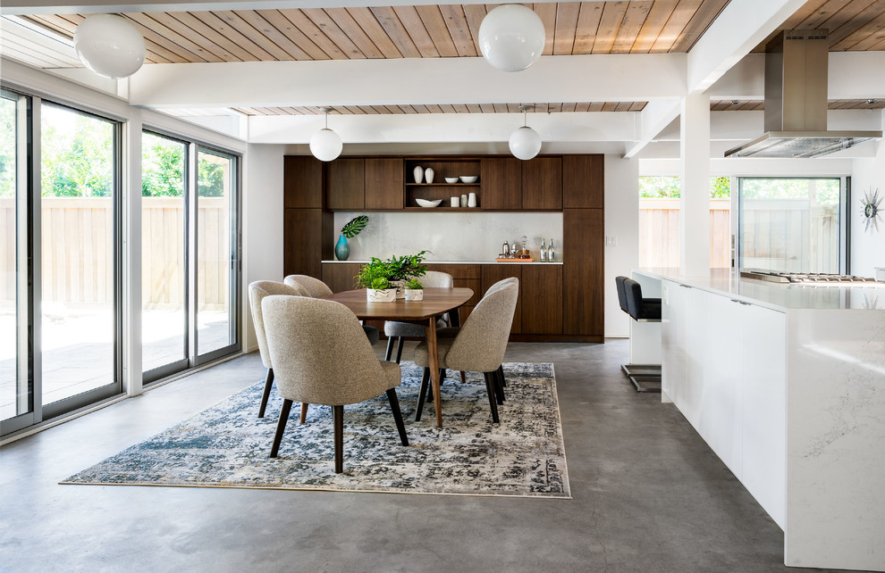Design ideas for a mid-sized midcentury kitchen/dining combo in Portland with white walls, concrete floors and grey floor.