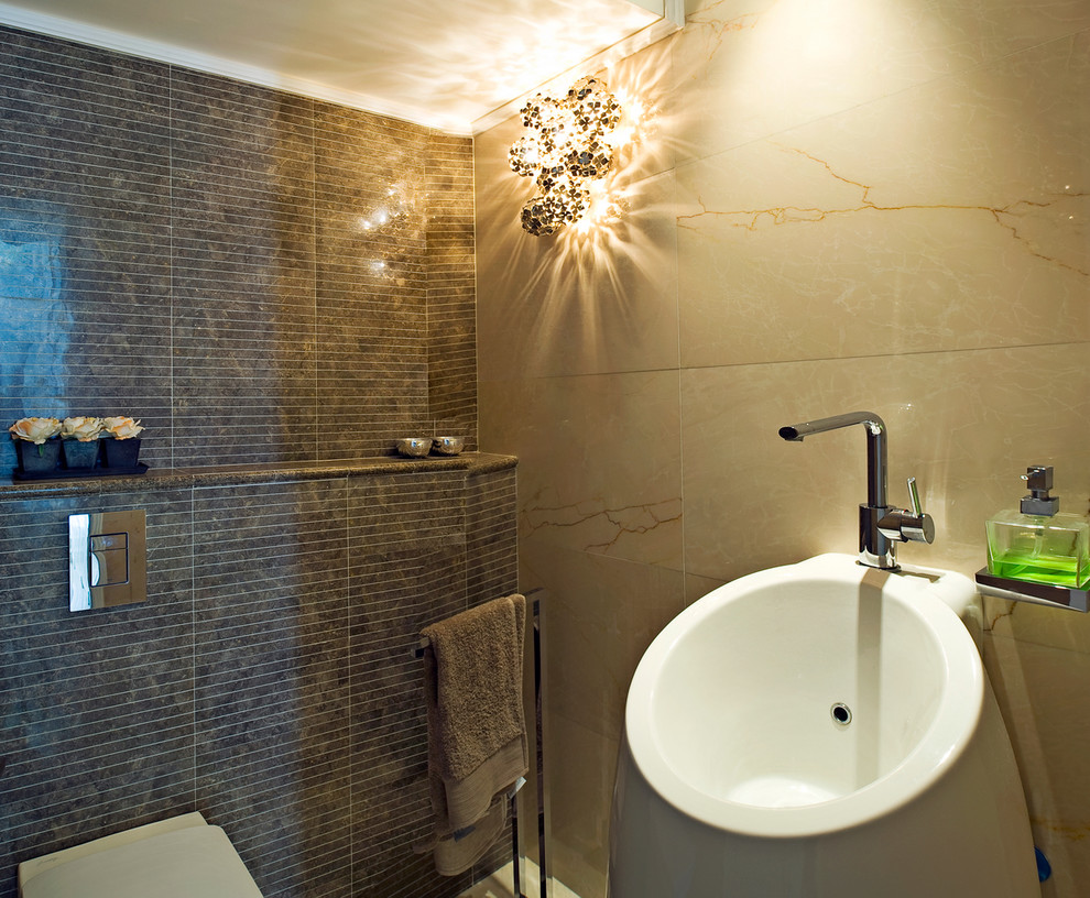 Design ideas for a contemporary bathroom in Tel Aviv with a pedestal sink and brown tile.