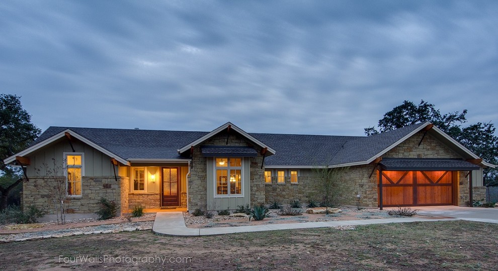 This is an example of a mid-sized arts and crafts one-storey beige exterior in Austin with stone veneer and a gable roof.