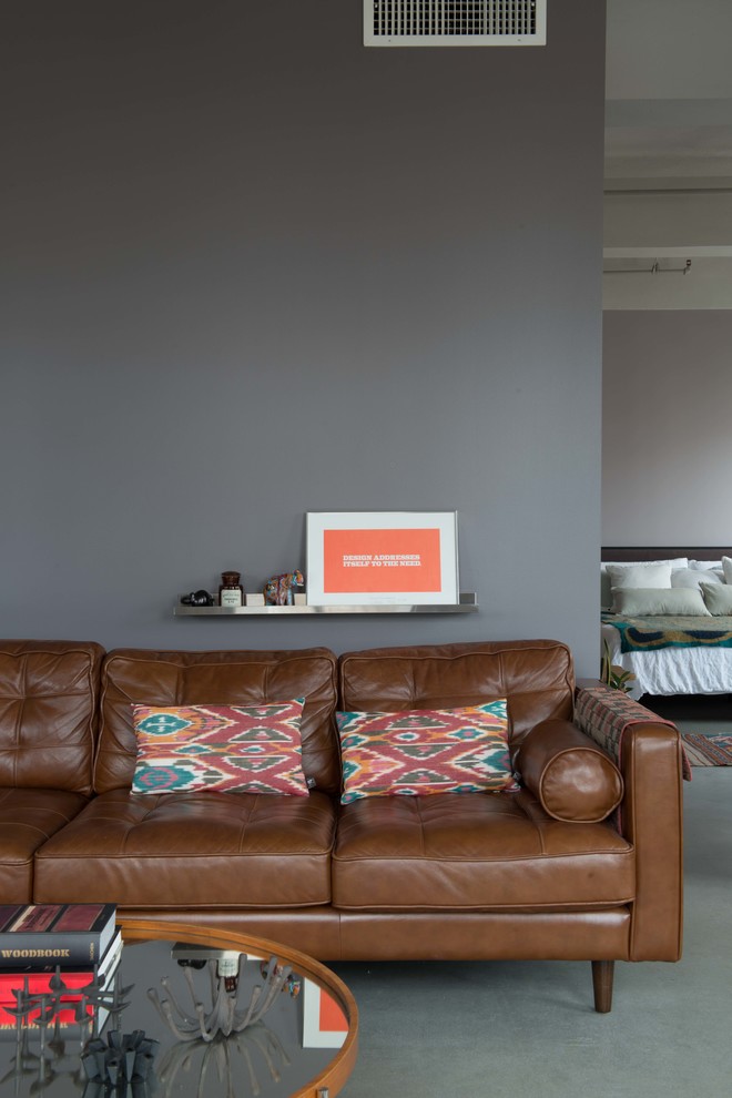 Example of a mid-sized urban formal and loft-style concrete floor living room design in Los Angeles with gray walls, no fireplace and no tv