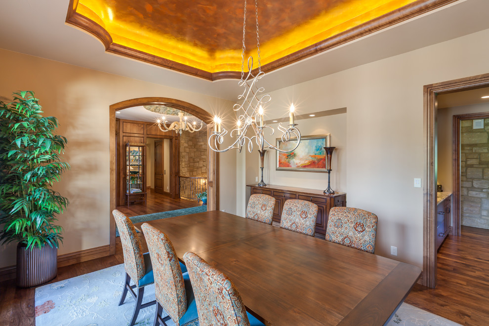 Mountain style medium tone wood floor enclosed dining room photo in Denver with beige walls and no fireplace