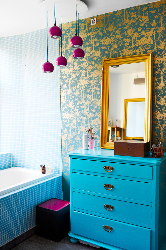 Eclectic bathroom in Copenhagen with blue cabinets, blue tile, mosaic tile and multi-coloured walls.