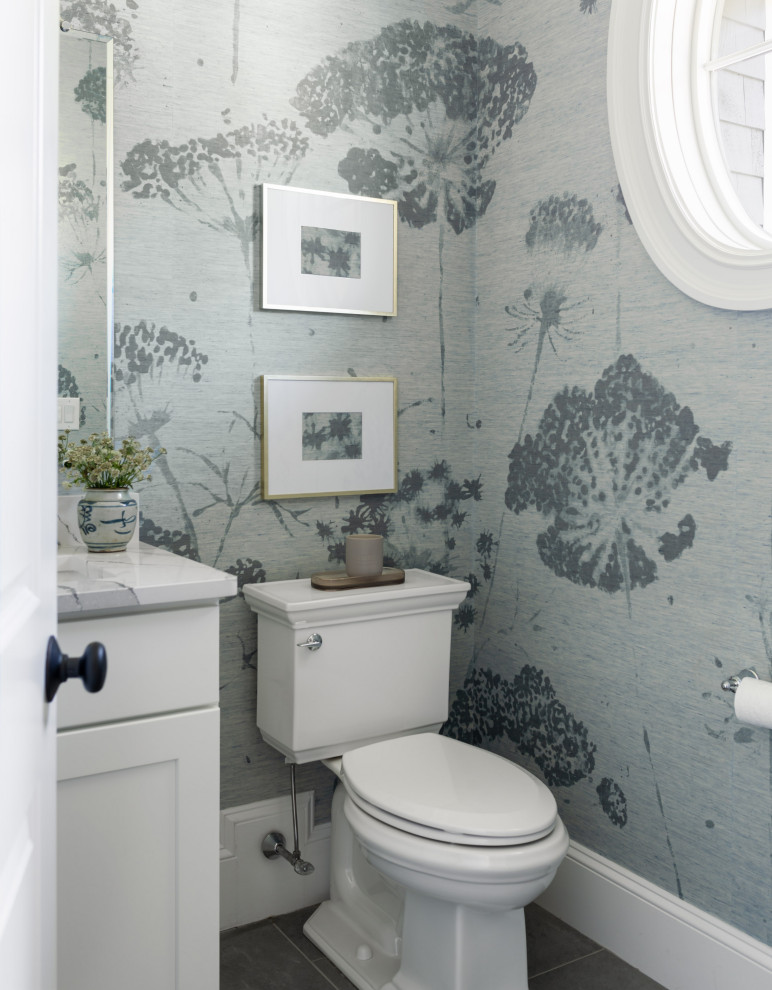 Inspiration for a transitional powder room in Boston with shaker cabinets, white cabinets, a two-piece toilet, multi-coloured walls and grey floor.