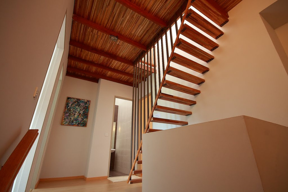Design ideas for a small country wood floating staircase in Other with wood railing.