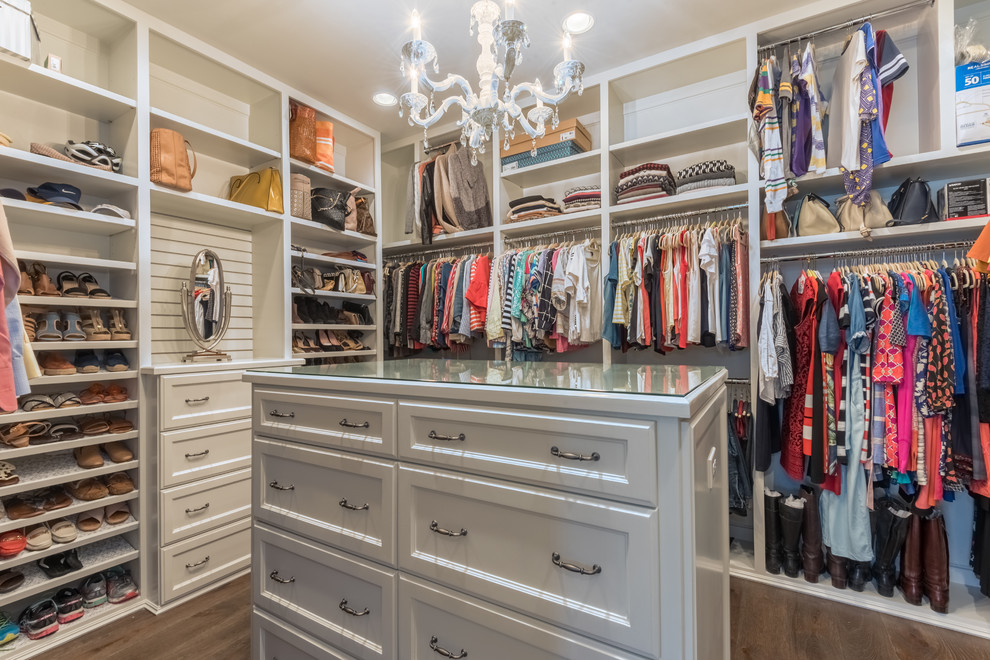 Design ideas for a large transitional women's dressing room in Houston with recessed-panel cabinets, white cabinets, dark hardwood floors and brown floor.