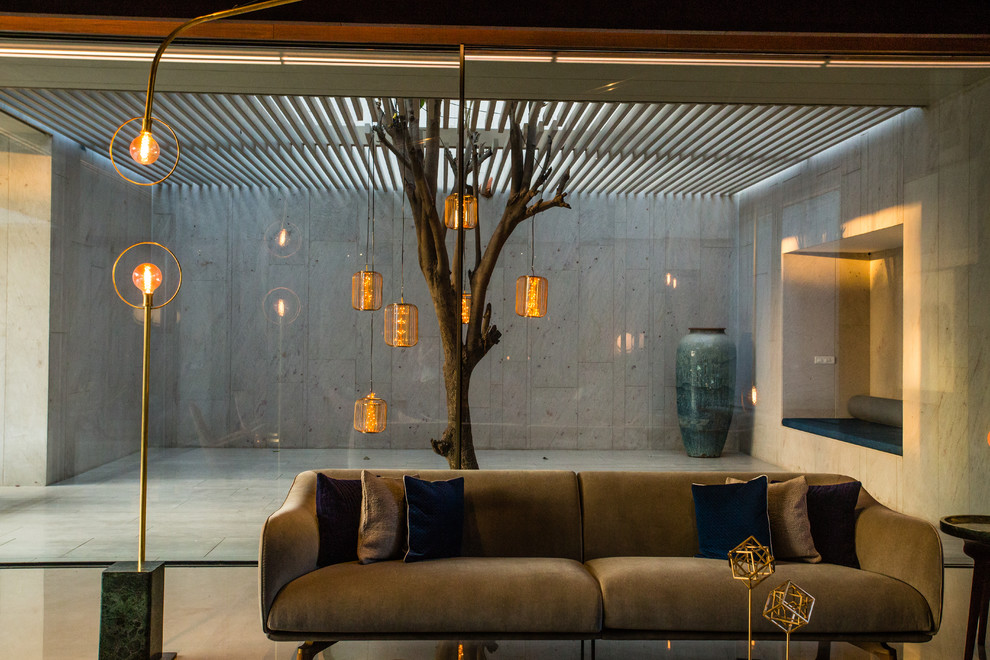 Photo of an Asian living room in Ahmedabad With Grey Walls, Concrete Floors and Gray.