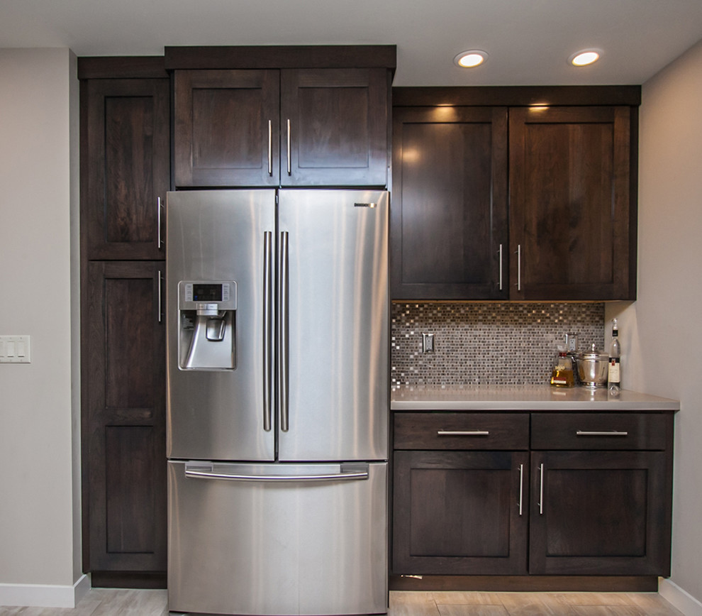 Example of a mid-sized transitional u-shaped light wood floor and beige floor eat-in kitchen design in Phoenix with an undermount sink, shaker cabinets, dark wood cabinets, granite countertops, multicolored backsplash, mosaic tile backsplash, stainless steel appliances and an island