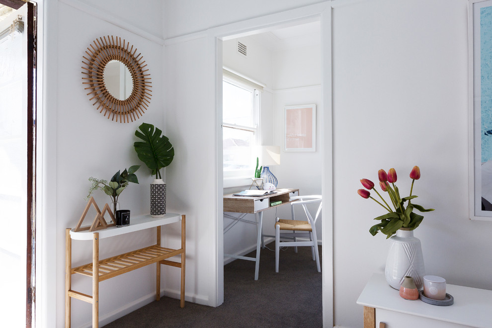 Scandinavian entry hall in Sydney with white walls, carpet and grey floor.