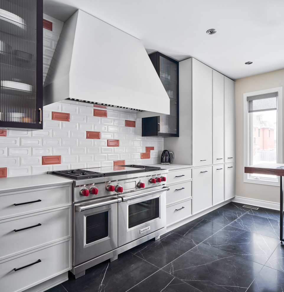 Contemporary single-wall kitchen in Ottawa with recessed-panel cabinets, white cabinets, multi-coloured splashback, stainless steel appliances, no island, black floor and white benchtop.