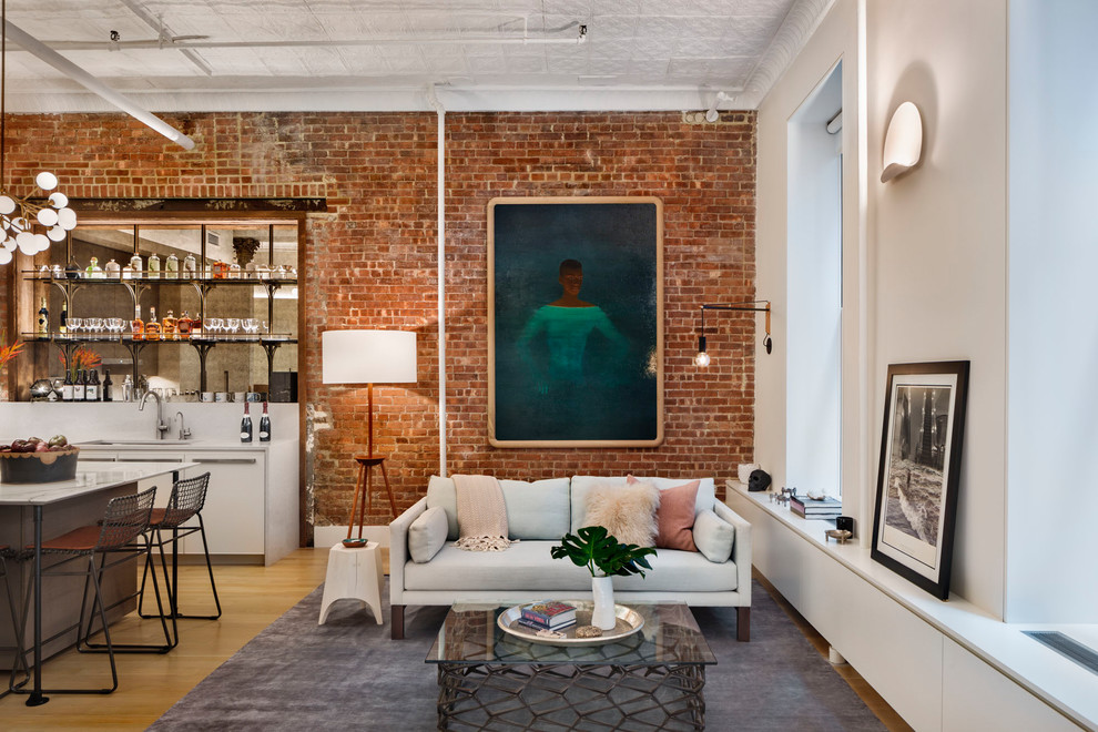 Inspiration for an industrial open concept living room in New York with white walls, light hardwood floors and no fireplace.
