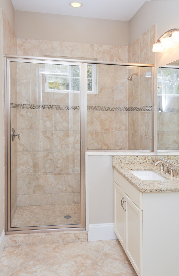 Small 3/4 bathroom in Atlanta with an undermount sink, flat-panel cabinets, beige cabinets, granite benchtops, beige tile, ceramic tile, beige walls and ceramic floors.