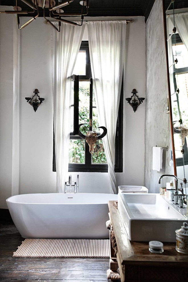 Inspiration for a country bathroom in Other with a vessel sink and a freestanding tub.