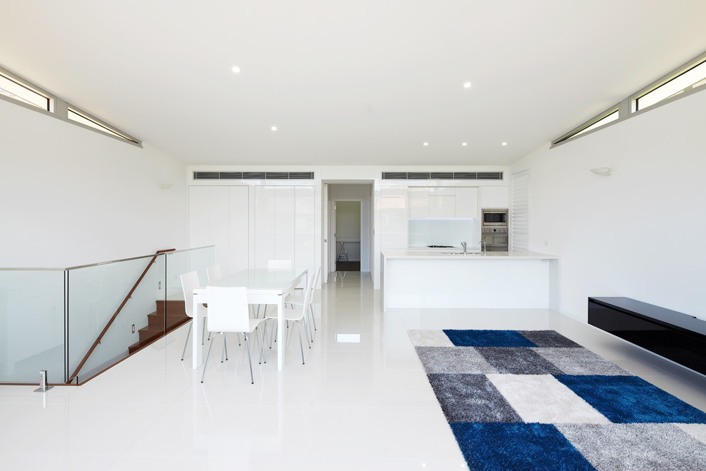 Photo of a small contemporary open concept living room in Sydney with white walls and porcelain floors.