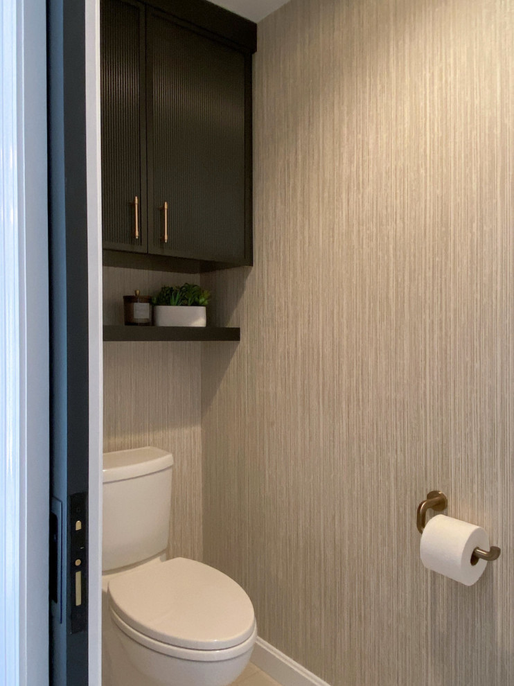 Large classic ensuite bathroom in Boston with black cabinets, a freestanding bath, an alcove shower, a two-piece toilet, beige tiles, porcelain tiles, beige walls, porcelain flooring, a submerged sink, engineered stone worktops, beige floors, a hinged door, beige worktops, an enclosed toilet, double sinks, a built in vanity unit and wallpapered walls.