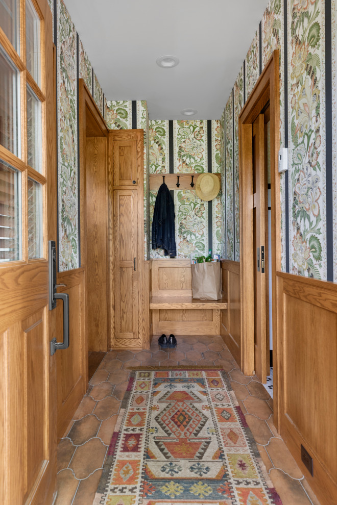 Inspiration for a small traditional entry hall in Minneapolis with multi-coloured walls, brown floor, decorative wall panelling and wallpaper.
