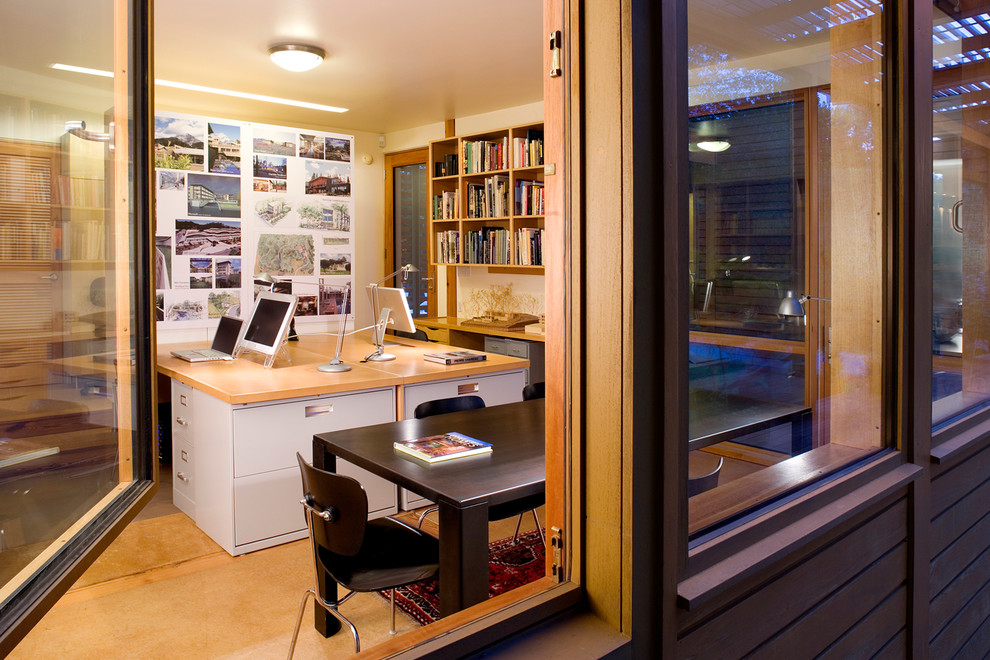 Inspiration for a small modern built-in desk concrete floor home studio remodel in Richmond with white walls