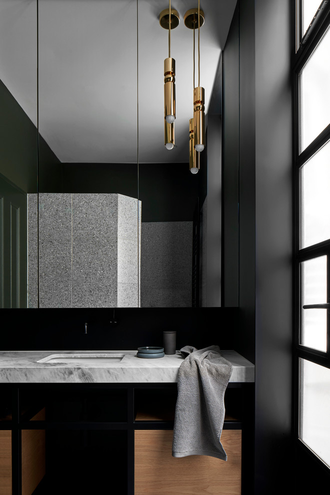 Photo of a mid-sized contemporary master bathroom in Melbourne with open cabinets, medium wood cabinets, an alcove shower, black tile, metal tile, black walls, cement tiles, an undermount sink, marble benchtops, grey floor, an open shower and grey benchtops.
