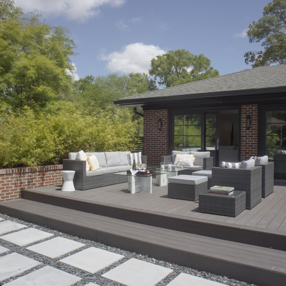 This is an example of a large contemporary backyard and ground level deck in Other with no cover.