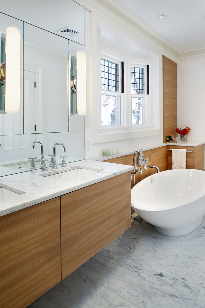 Contemporary bathroom in Boston with marble benchtops and an undermount sink.