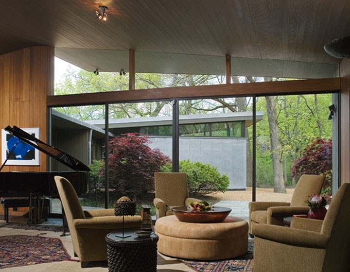 This is an example of a large midcentury open concept family room in Chicago with brown walls.