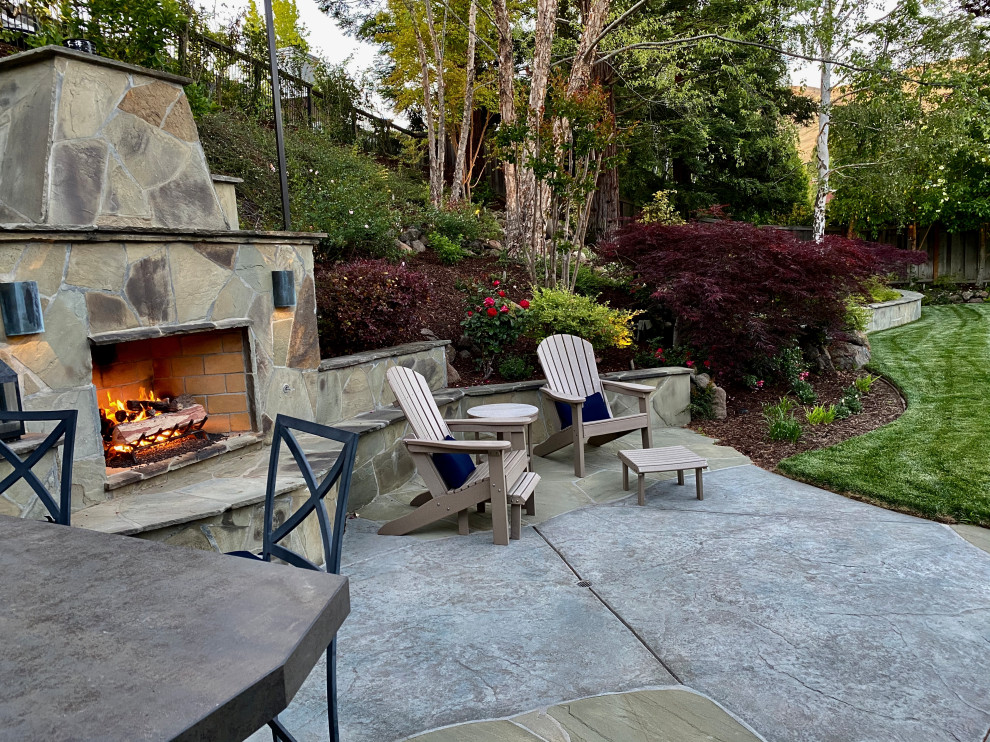 This is an example of a medium sized traditional back patio in San Francisco with an outdoor kitchen and stamped concrete.