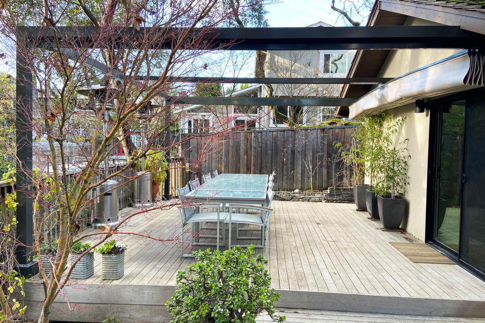 Design ideas for a medium sized modern back ground level wood railing terrace in San Francisco with a pergola.