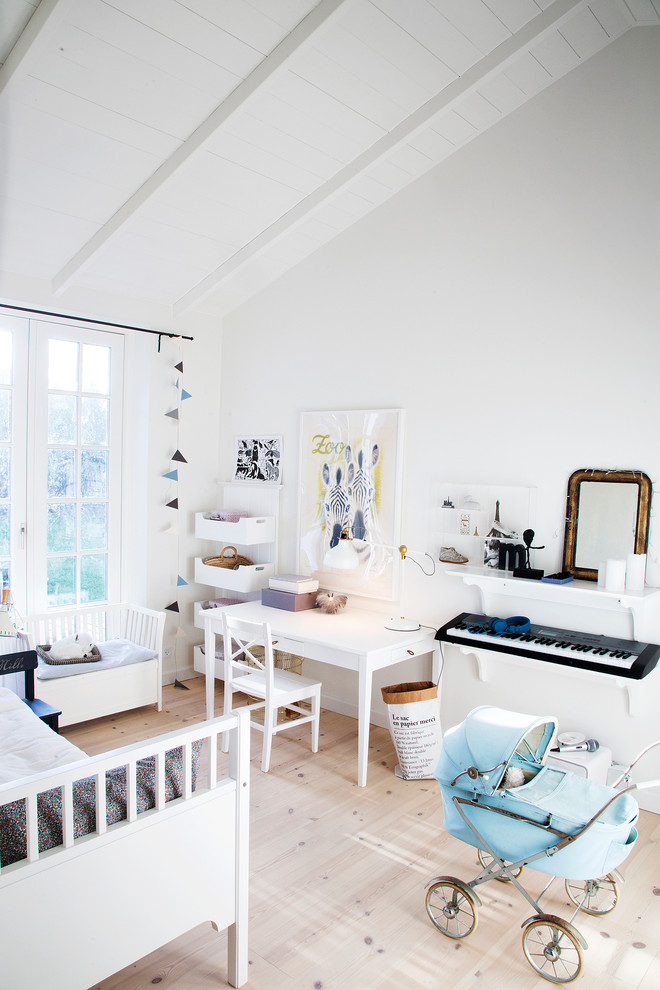 Design ideas for a mid-sized scandinavian gender-neutral kids' room for kids 4-10 years old in Copenhagen with white walls.