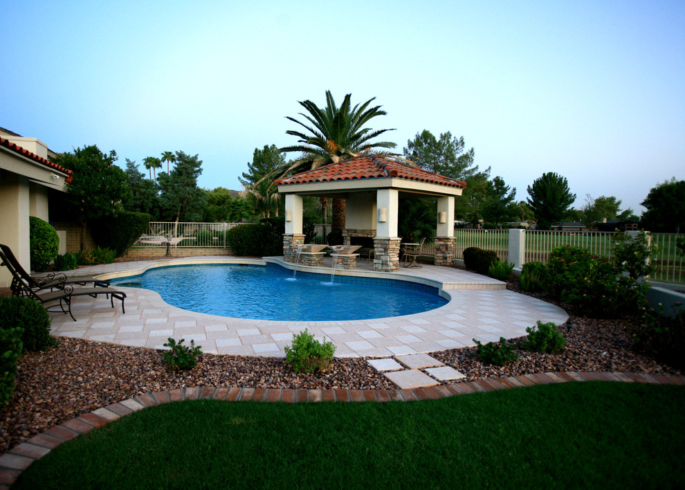 Pool house - mid-sized transitional backyard custom-shaped natural pool house idea in Phoenix with decking