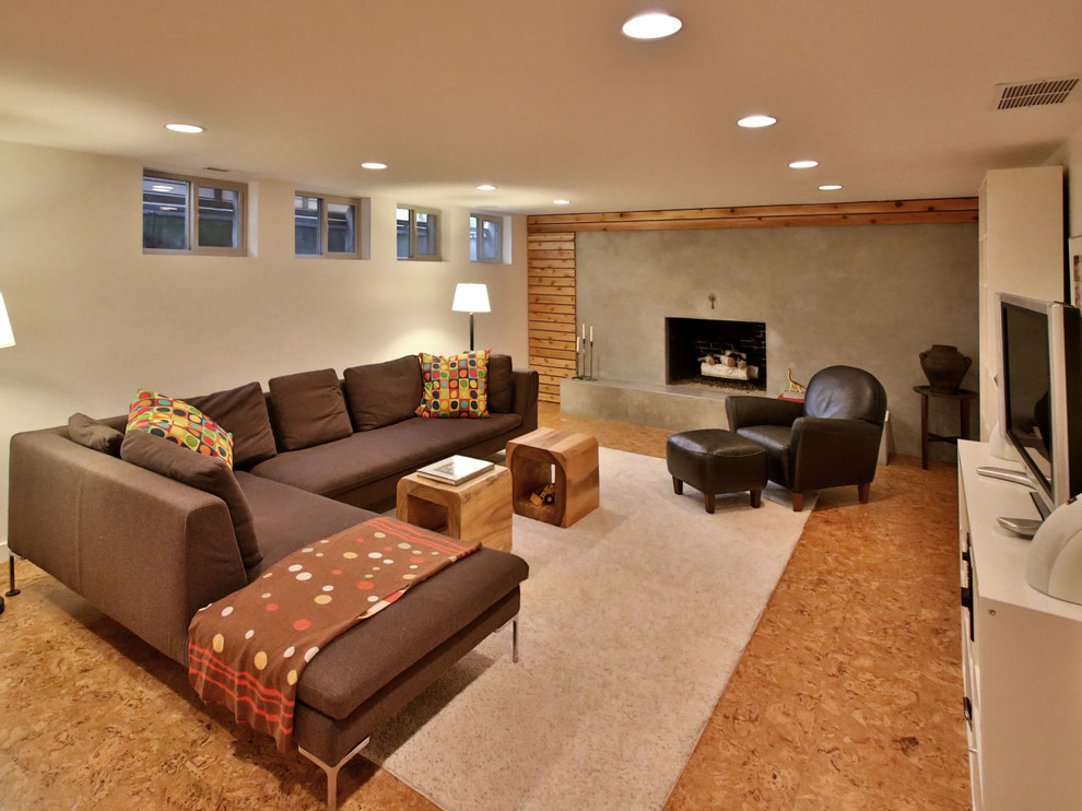Photo of a contemporary family room in Portland with a concrete fireplace surround.