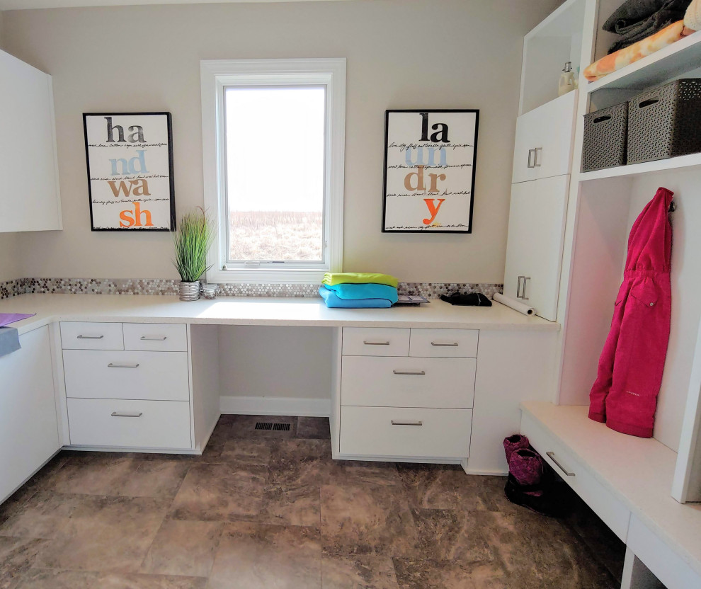 Utility room - large transitional u-shaped utility room idea with flat-panel cabinets, white cabinets, quartz countertops and white countertops