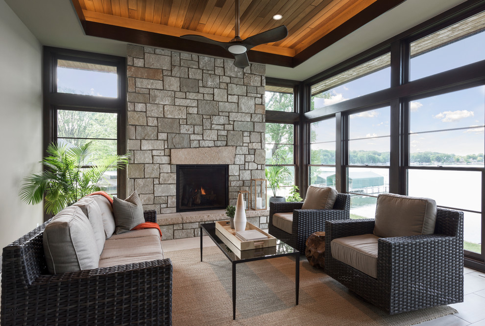 Inspiration for a large contemporary sunroom in Minneapolis with porcelain floors, a standard fireplace, a stone fireplace surround and a standard ceiling.