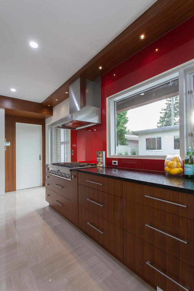 Large modern u-shaped eat-in kitchen in Vancouver with an undermount sink, flat-panel cabinets, medium wood cabinets, granite benchtops, red splashback, glass tile splashback, stainless steel appliances, porcelain floors and with island.