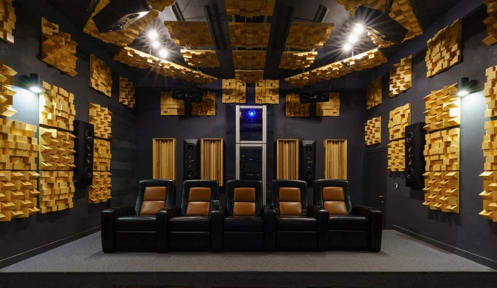 This is an example of a contemporary enclosed home theatre in Los Angeles with black walls, carpet and grey floor.