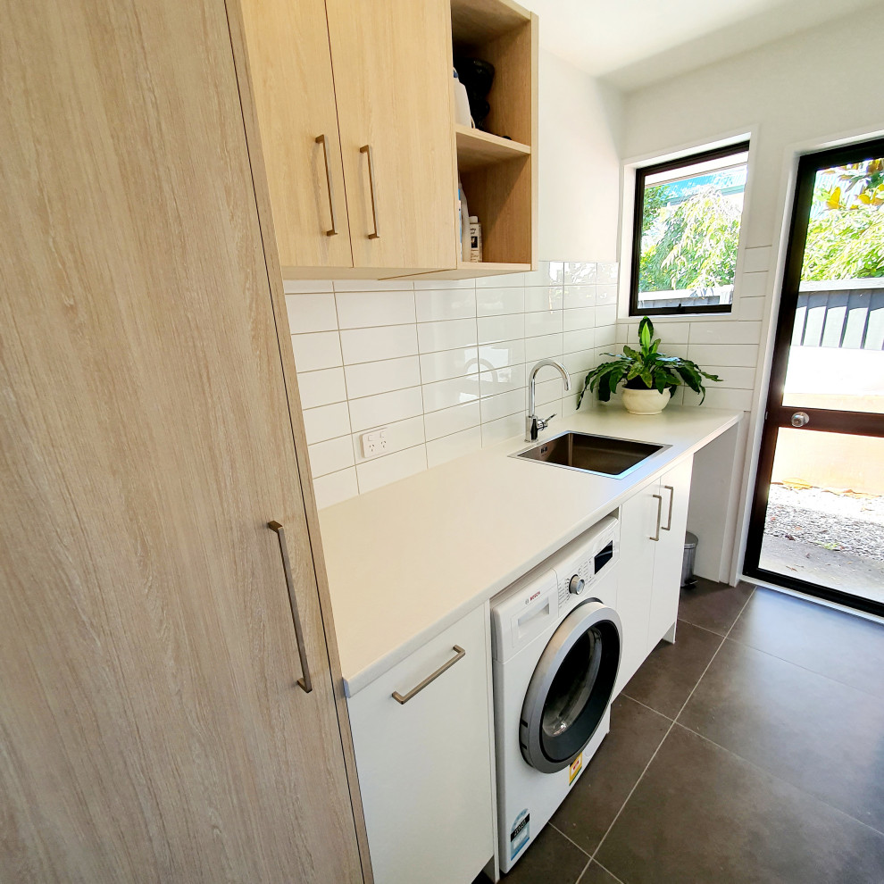 This is an example of a contemporary utility room in Christchurch with a single-bowl sink, laminate benchtops and white benchtop.
