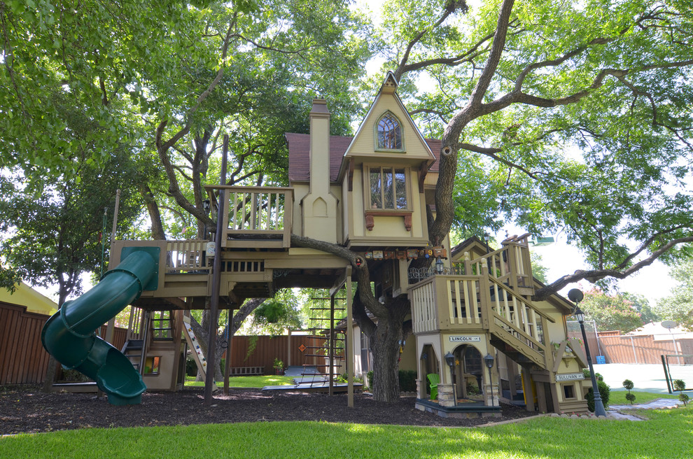 This is an example of a traditional garden in Dallas with with outdoor playset.