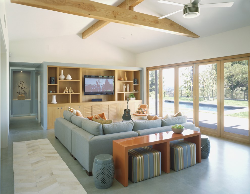 This is an example of a contemporary living room in Los Angeles with a built-in media wall.
