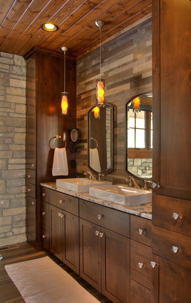 Photo of a country master bathroom in Minneapolis with flat-panel cabinets, medium wood cabinets, a claw-foot tub, an alcove shower, a two-piece toilet, multi-coloured tile, stone tile, medium hardwood floors, a drop-in sink, granite benchtops, brown floor and a hinged shower door.