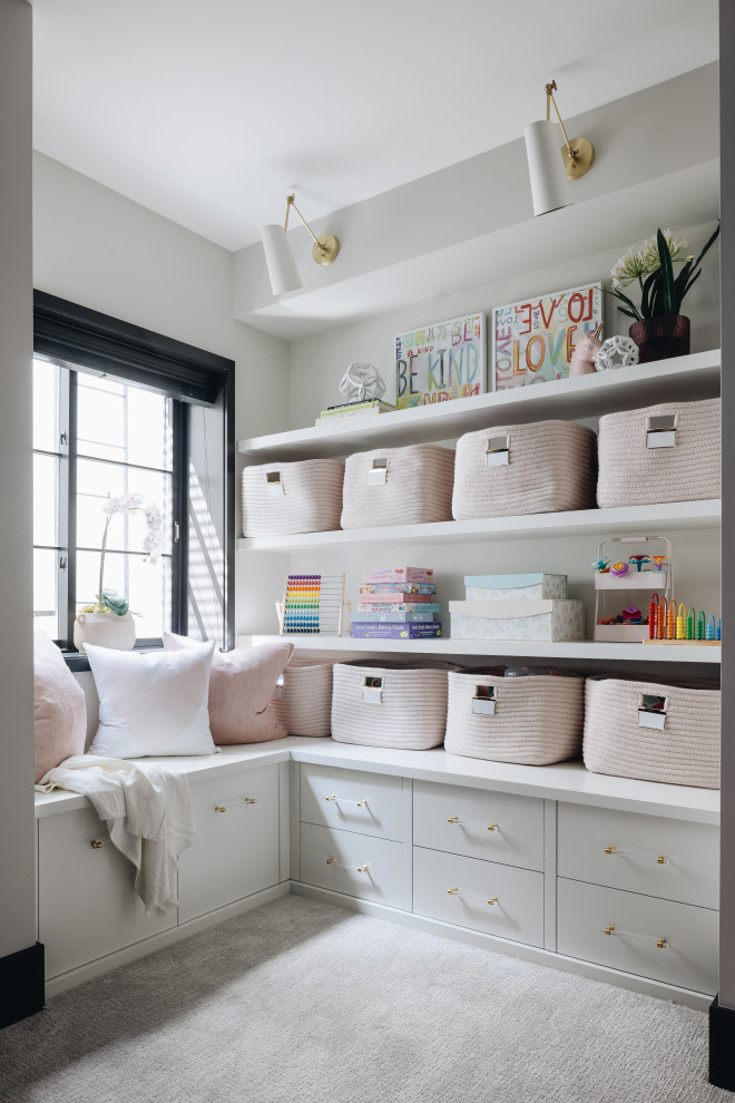 Inspiration for a large transitional kids' playroom for kids 4-10 years old and girls in Chicago with white walls, carpet and white floor.