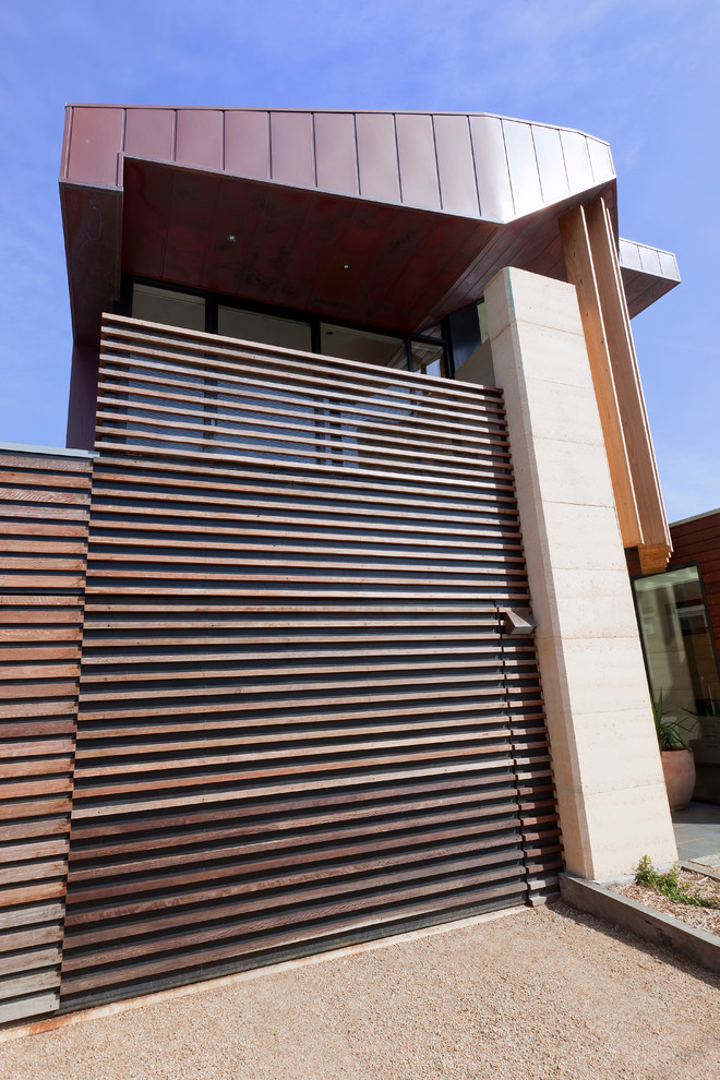 Contemporary brown exterior in Melbourne with wood siding.