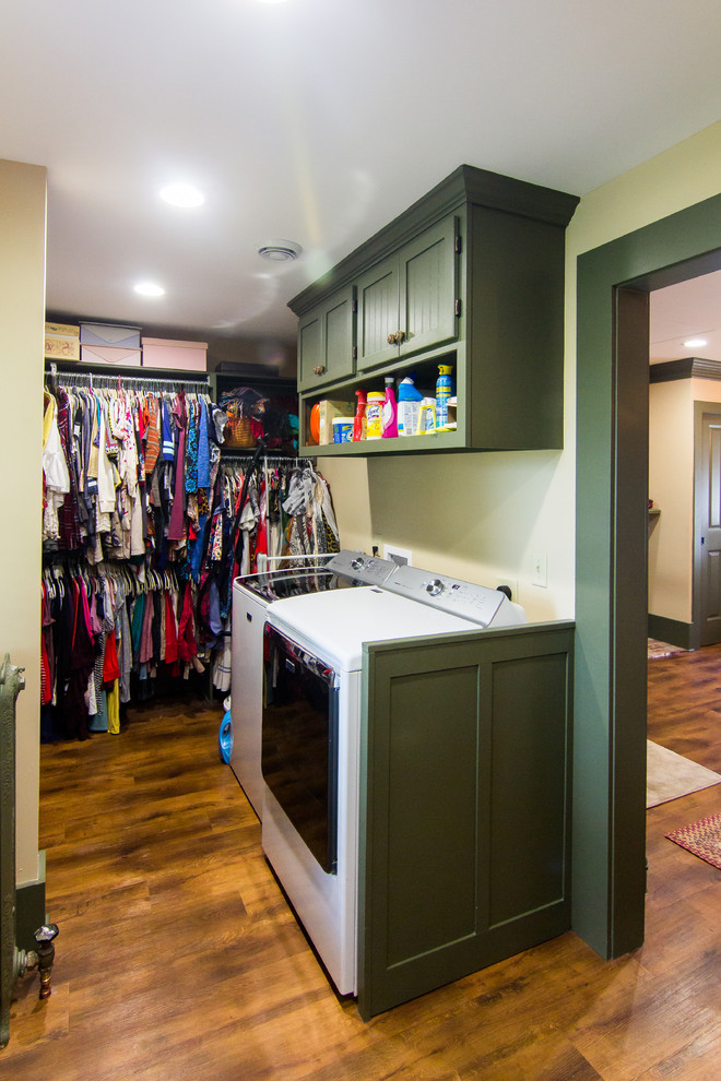 Example of a large mountain style master medium tone wood floor freestanding bathtub design with furniture-like cabinets, beige cabinets, a two-piece toilet, beige walls, an undermount sink, solid surface countertops and a hinged shower door