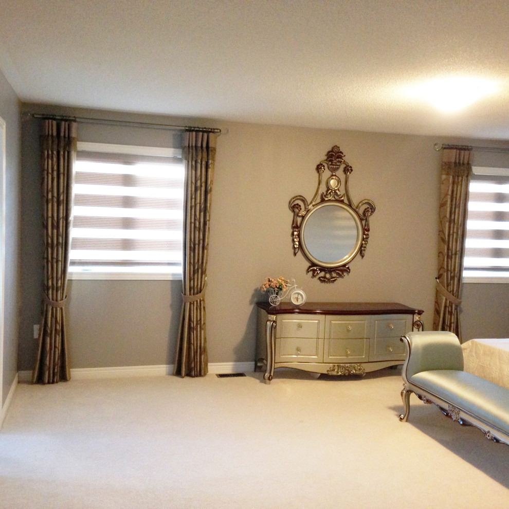 Large contemporary master bedroom in Toronto with grey walls, carpet and beige floor.