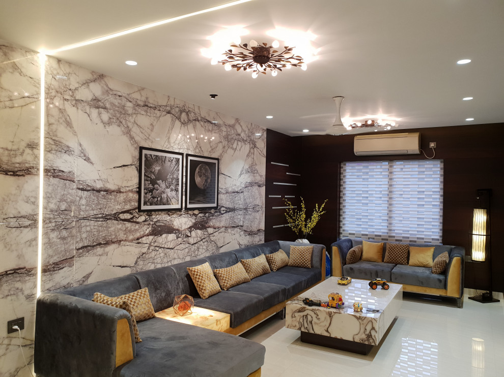 Inspiration for a contemporary living room in Kolkata with marble flooring, beige floors and panelled walls.