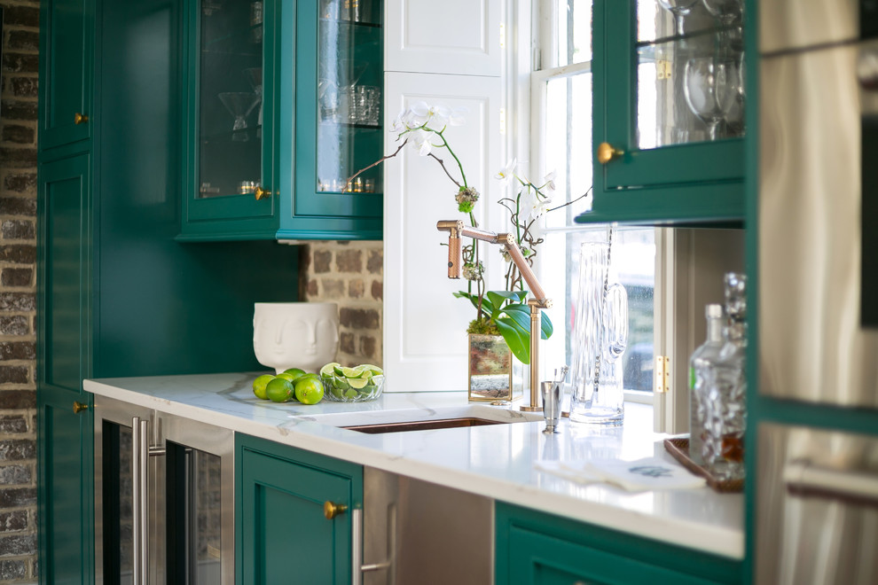 Inspiration for a mid-sized transitional home bar in Charleston with beaded inset cabinets, green cabinets, quartz benchtops, brown splashback, brick splashback, medium hardwood floors, brown floor and white benchtop.