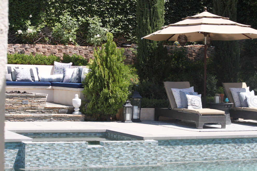 Large transitional backyard concrete and rectangular pool photo in Los Angeles
