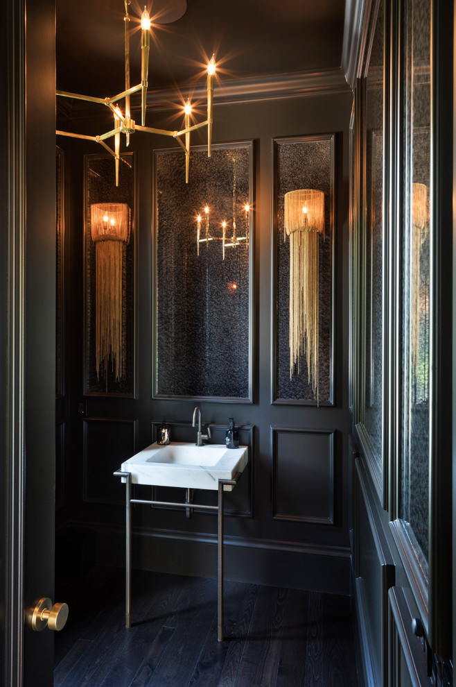 Inspiration for a mediterranean powder room in Minneapolis with black walls, dark hardwood floors, a console sink and brown floor.