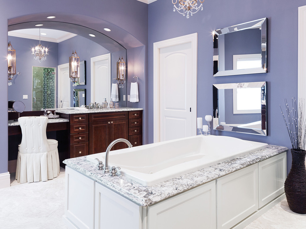 Photo of a large traditional master bathroom in Other with dark wood cabinets, a drop-in tub, gray tile, purple walls, ceramic floors, recessed-panel cabinets, an undermount sink, quartzite benchtops, white floor and multi-coloured benchtops.